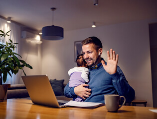 A happy father and businessman having video call on the laptop with colleagues from home.