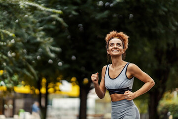 Sportswoman running in a public park and doing her morning routine. 
