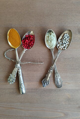 Antique spoons with spices. Nutmeg, pepper, turmeric. Cutlery.