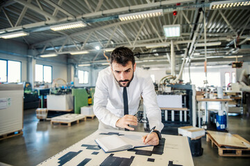 A printing shop engineer analyzing prints.