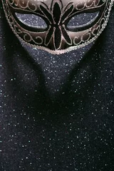 Foto op Canvas Elegant black carnival mask on a dark background with sequins closeup with copy space © Alex M