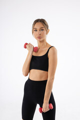 training with dumbbells of a beautiful young female on a white background 