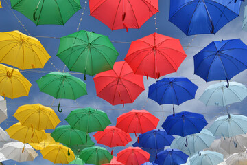 Colorful umbrellas hanging high in the sky