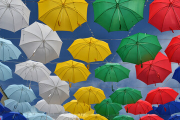 Fototapeta na wymiar Colorful umbrellas hanging high in the sky