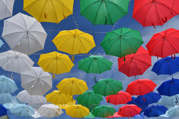 Colorful umbrellas hanging high in the sky