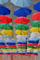 Colorful umbrellas hanging high in the sky