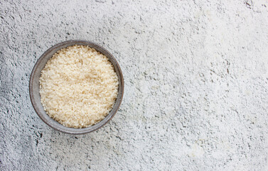 grey bowl with rice on background with copy space for your text, top view. Natural food high in protein