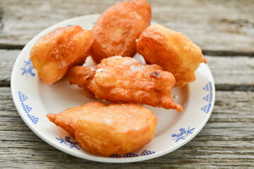 Traditional home made deep fried  patties  covered with sugar  оn rustic backgroud.Mekitsa or Mekica,  on wooden  rustic  background. Made of kneaded dough that is deep fried  .Carnival tortelli stuff