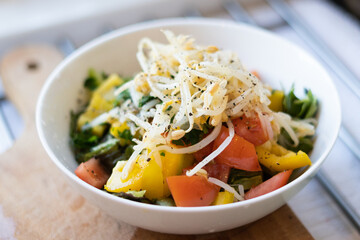 Salad with bell pepper, tomato, beansprouts, fresh parsley in a bowl, vegetarian, vegan food, diet