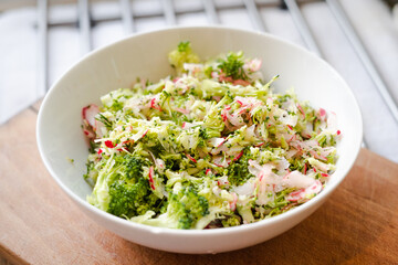 Salad with raw broccoli, raddish and fresh dill, diet, post, vegan, vegetarian