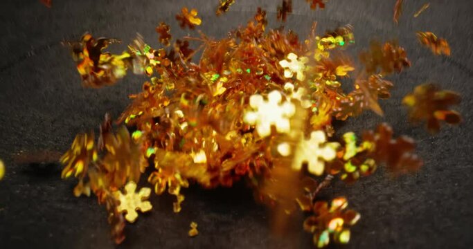 Small colorful particles shaking against dark background