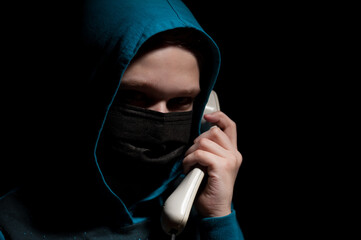 Unknown person with covered face makes an anonymous call intimidating and threatening the...