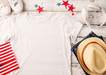 Mockup design white t shirt for logo, top view on white wooden background with US flag and...