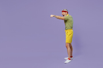 Full size body length elderly gray-haired bearded man 40s years old in headband khaki t-shirt look aside stand in boxing pose punch isolated on plain pastel light purple background studio portrait