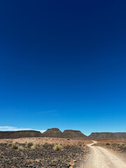 Gravel road in desert. Sandy landscape, nobody. Nature in Namibia, Africa