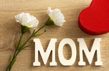 Happy Mother's Day. Mom letters and flowers on wooden background. Flat, top view.	
