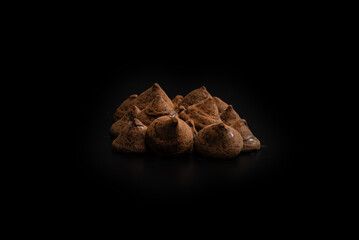 Chocolate truffles on a black background.