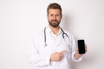 Young smiling male doctor showing screen mobile phone isolated on white background. Medical concept.