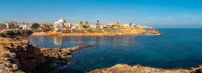 Fototapeta premium Panoramic view of Cala de la Higuera next to Los Locos beach in the coastal city of Torrevieja, Alicante, Valencian Community. Spain, Mediterranean Sea on the Costa Blanca