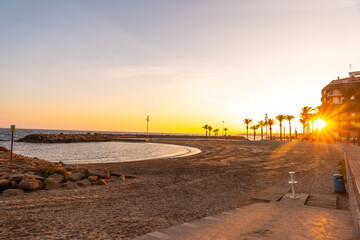 Obraz premium Orange sunset at Playa del Cura in the coastal town of Torrevieja, Alicante, Valencian Community. Spain, Mediterranean Sea on the Costa Blanca