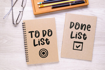 Two separated notebooks with text: To Do List and Done List, on the desk, as memo for tracking what have already achieved