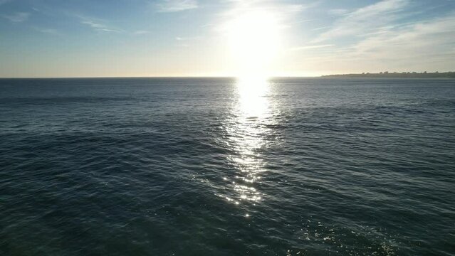 Image from the sun reflecting on calm sea at Cascais Coast, Portugal.