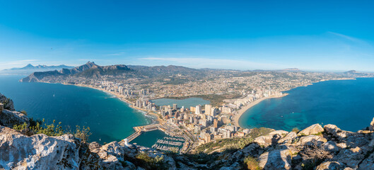 Obraz premium Panoramic views of the city of Calpe from the top in the Penon de Ifach Natural Park, Valencia, Valencian Community. Spain. Mediterranean sea. Cantal Roig and La Fossa beach