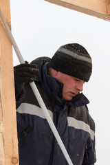 Worker assembling the frame of a wooden slide