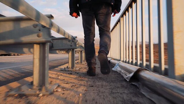 Man walking on bridge