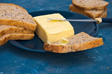 butter and toast bread on a blue plate. close. macro.