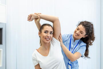 Doctor or Physiotherapist working examining treating injured arm of athlete patient, stretching and exercise, Doing the Rehabilitation therapy pain in clinic. - obrazy, fototapety, plakaty