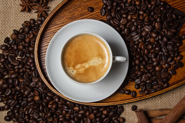 Espresso coffee on the background of coffee beans. Tonic drink. Cup of natural coffee
