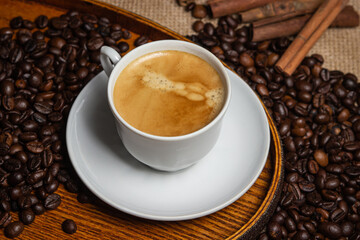 Espresso coffee on the background of coffee beans. Tonic drink. Cup of natural coffee