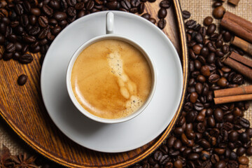 Espresso coffee on the background of coffee beans. Tonic drink. Cup of natural coffee