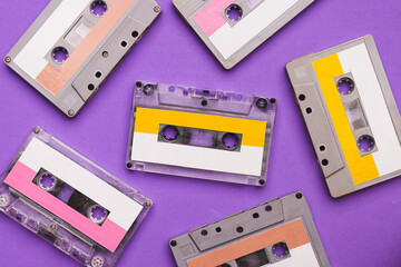 Collection of cassette tapes on purple background.