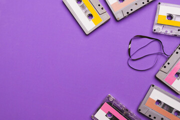 Fototapeta premium Collection of cassette tapes on purple background. Copy space fot text