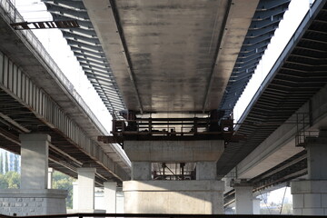 under a huge bridge of concrete and steel