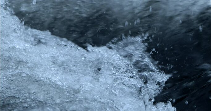 Close-up of water in slow motion on a river with single drops of water.