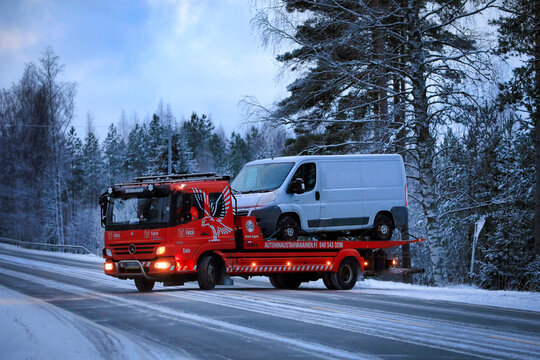 Mercedes-Benz Atego Tow Truck Carryig Breakdown Van Enters Highway on a Winter Evening