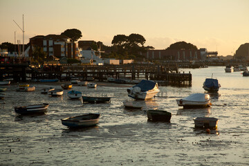 Small boats resting on the mud at low tide, sandbanks in Poole