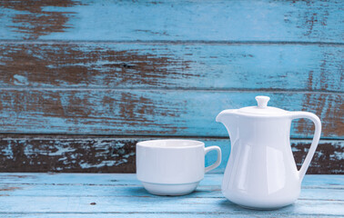 Fototapeta na wymiar Set of white teacups on a blue wooden floor