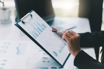 Financial businessman calculating corporate income tax data And analyzing charts of financial...