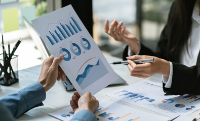 Asian business adviser meeting to analyze and discuss the situation on the financial report in the...