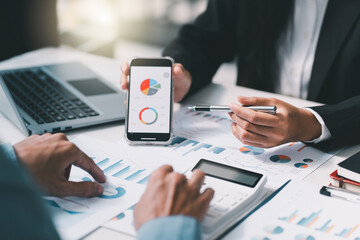 Asian business adviser meeting to analyze and discuss the situation on the financial report in the meeting room.Investment Consultant,Financial Consultant,Financial advisor and accounting concept