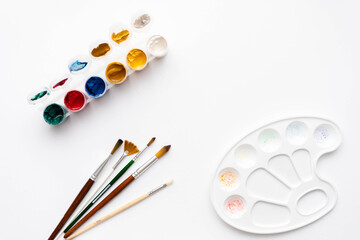 Flat composition set of artistic tools. Brushes, paints, pencils, pastels for drawing. Place for text.
