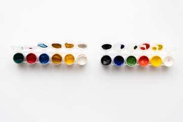 Flat composition a set of multi-colored paints in jars. Space for the text.