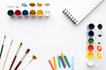 Flat composition set of artistic tools. Brushes, paints, pencils, pastels for drawing. Place for text.
