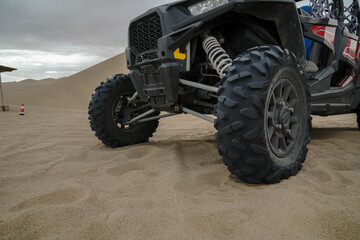 Atv in desert, closeup view on wheel. © Leo Li