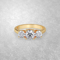 3 stone engagement ring laying down position in yellow gold 3D render