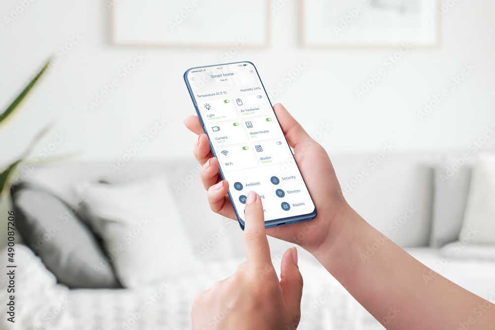 Poster smart home control app. automated control and monitor of home attributes concept. phone in woman han